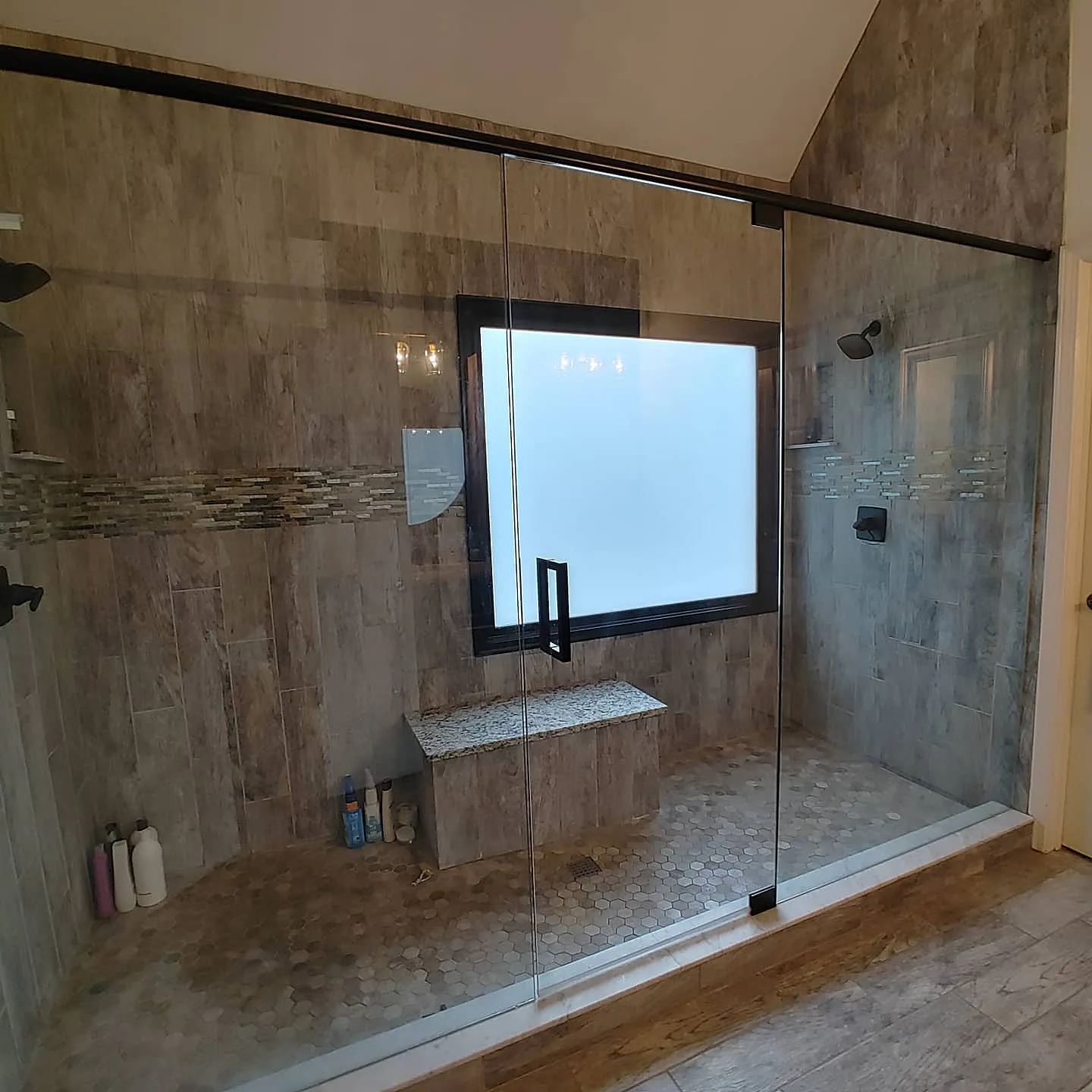 Luxury master bath shower with frosted white privacy film on window